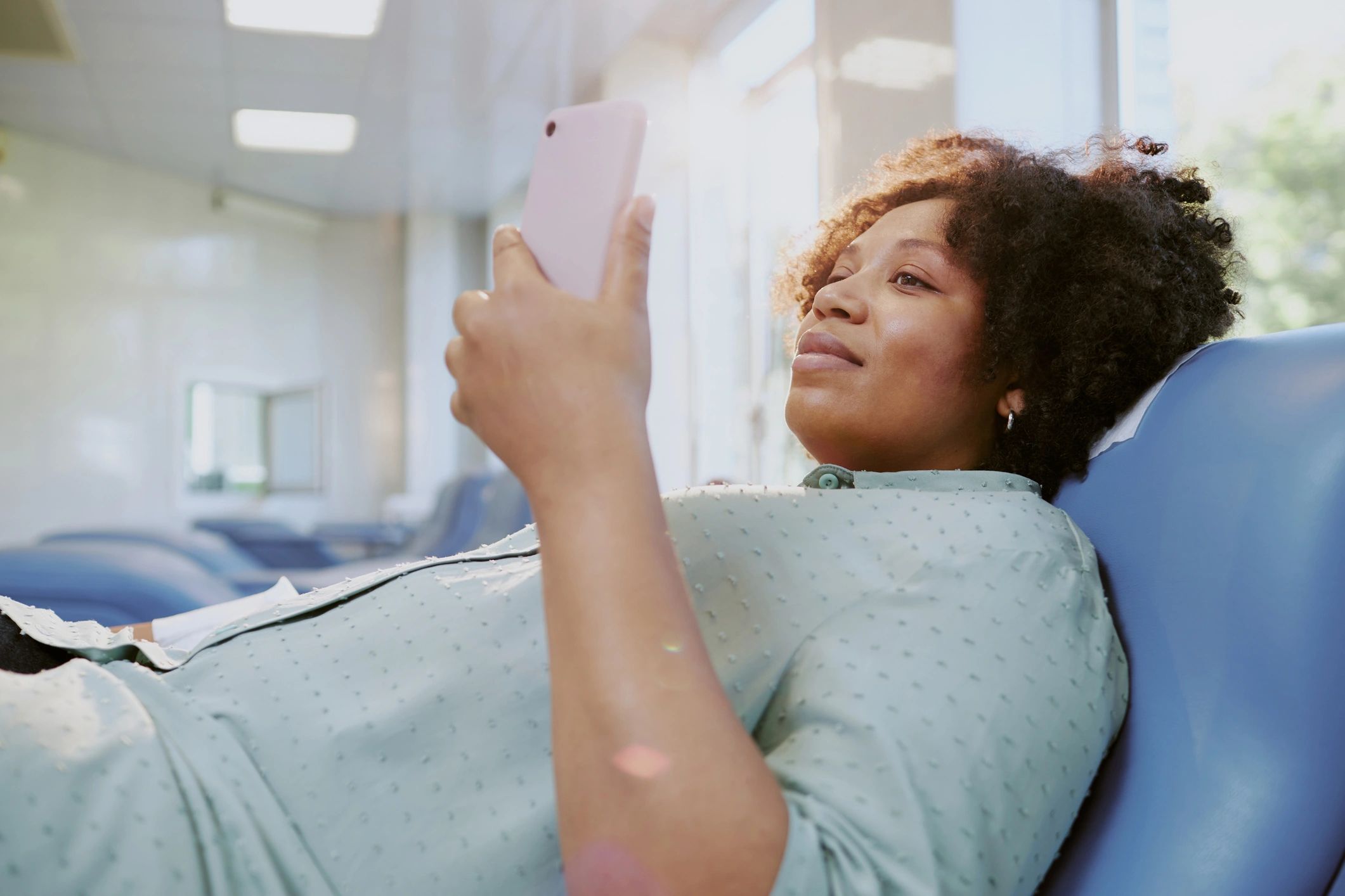 Person using a phone in a calm healthcare setting